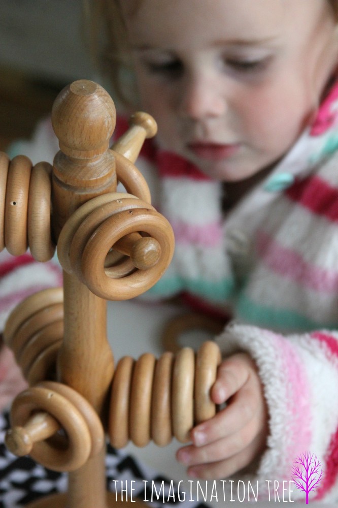Wooden rings on a mug tree make a great learning toy for babies and toddlers!