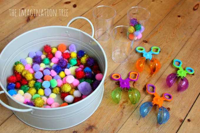 Fine motor game for preschoolers with pom poms and scoops
