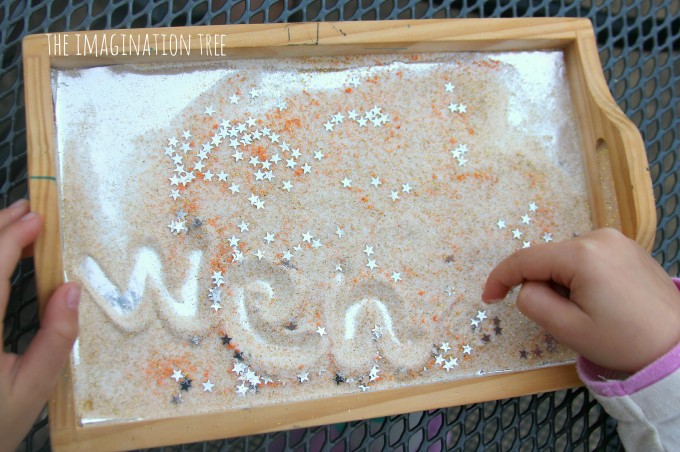 Writing in a star dust sensory tray