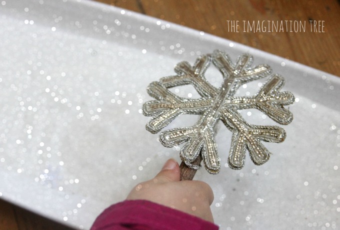 Writing in a sparkly snow sensory tray