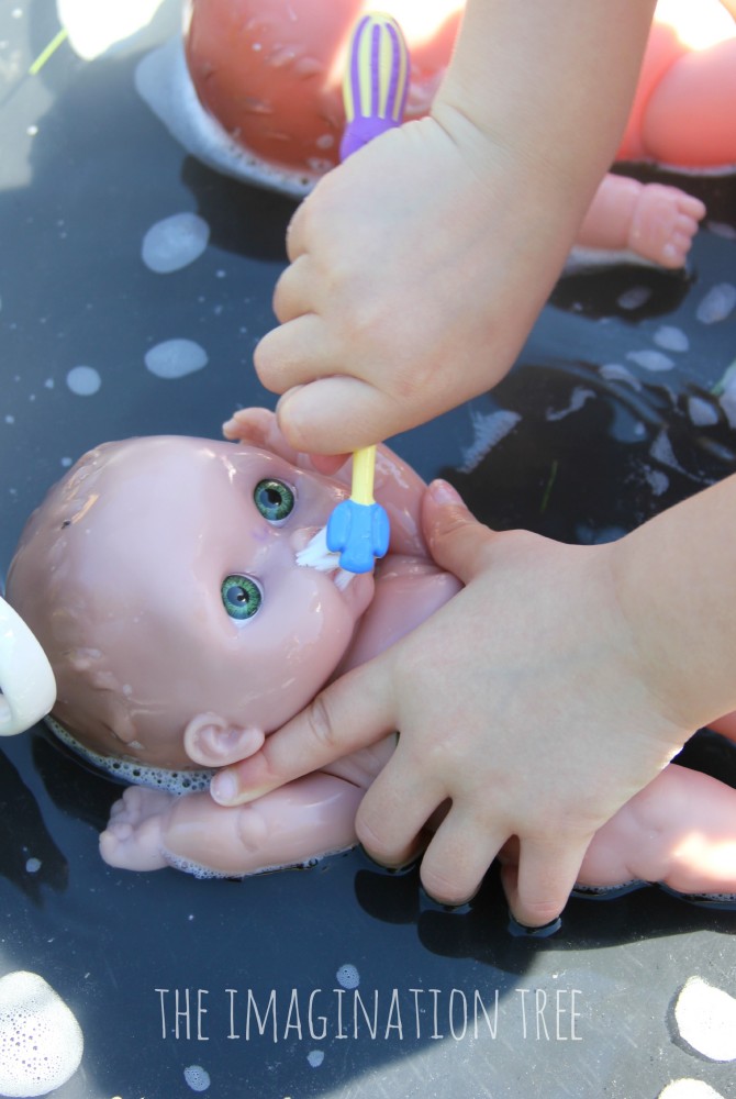 Brushing baby doll teeth- water play activity